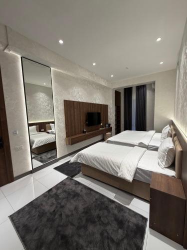 a bedroom with a large bed and a large mirror at NINETY boutique hotel in Yakkasaray