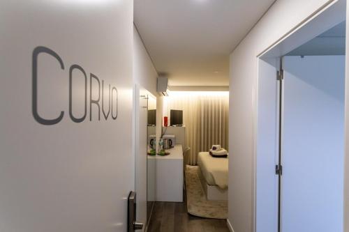 a hotel room with a door leading to a bedroom at GuestReady - Passal Guesthouse in Ponta Delgada