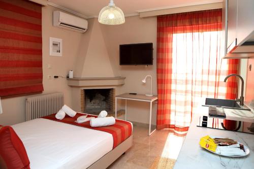 a bedroom with a bed and a desk and a television at Best House Erato Neo Faliro Piraeus in Piraeus