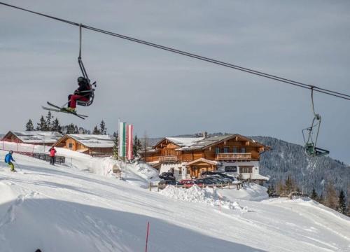 a person on skis jumping under a ski lift at Chalet Torstein in Schladming