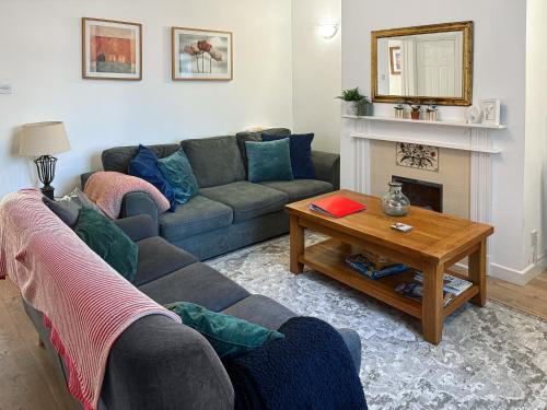 a living room with a couch and a table at 6 Mill Road in Okehampton