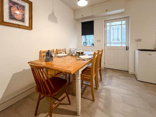 a kitchen and dining room with a wooden table and chairs at 6 Mill Road in Okehampton