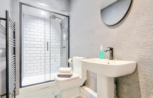 a bathroom with a sink and a toilet and a shower at The Norton Apartment by GR Estates in Stockton-on-Tees