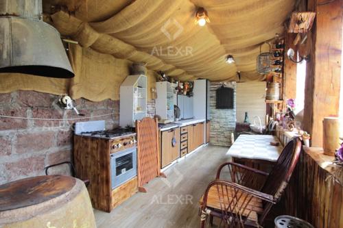 a kitchen with a stove and a table in a room at Full Panorama Guest House in Aparan