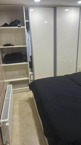 a bedroom with a bed and an open closet at pasanauri gudauri in Passanauri