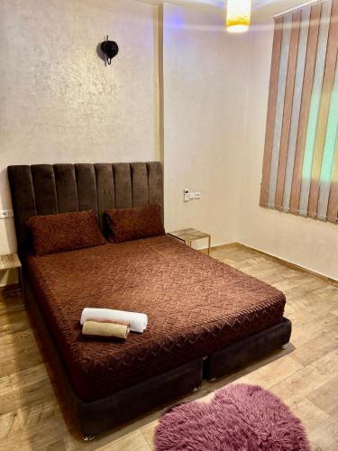 a bedroom with a bed with two towels on it at Apartment, well equipped in Fez