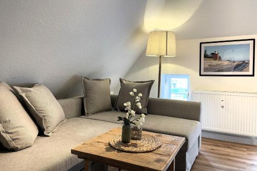 a living room with a couch and a table at Ole in Borgsum in Borgsum