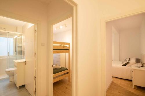 a room with a bathroom with a bed and a toilet at Apartamento Playa Sella in Ribadesella