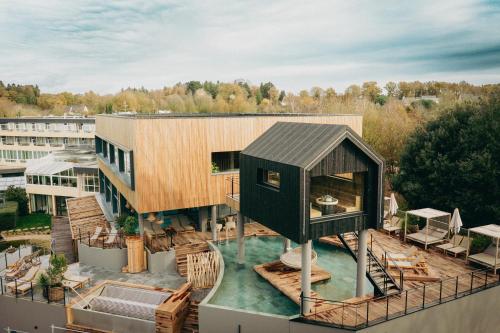 a house on the roof of a building at Best Western Plus Le Roi Arthur Hôtel & Spa in Ploërmel
