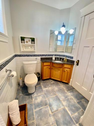 a bathroom with a toilet and a sink at The Sealy Residence in Saint John