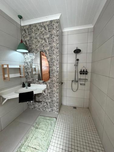a bathroom with a sink and a shower at Meander Stay Clarens in Clarens