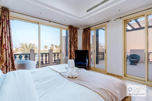 a bedroom with a bed with a towel on it at 5 Bedroom Villa with Pool - Near Al-Marjan Island in Ras al Khaimah