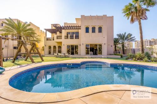 a large swimming pool in front of a house at 5 Bedroom Villa with Pool - Near Al-Marjan Island in Ras al Khaimah