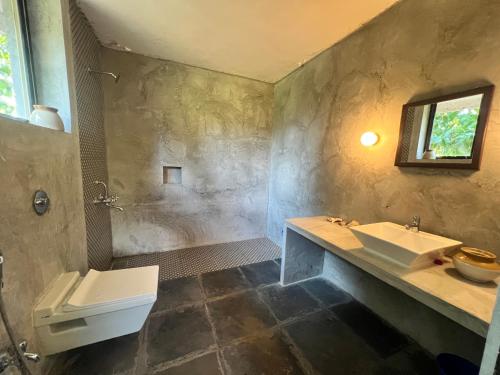 a bathroom with a sink and a toilet at Atithi Parinay Homestay in Ratnagiri
