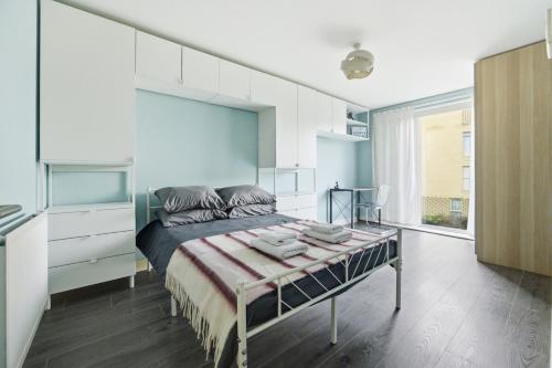 a bedroom with a bed and a large window at Steps from Train Station - Modern 2-Bedroom with Balcony & Cambridge Amenities, Family Friendly in Cambridge