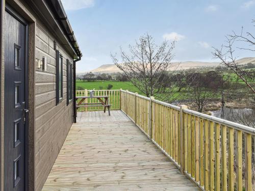 a wooden walkway leading to a building with a bench at The View - Uk36812 in Whalley