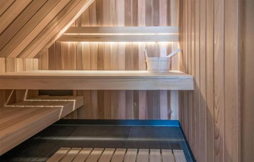 a sauna with a cup on a wooden shelf at Gorgeous Home In Den Ham With Sauna in Den Ham