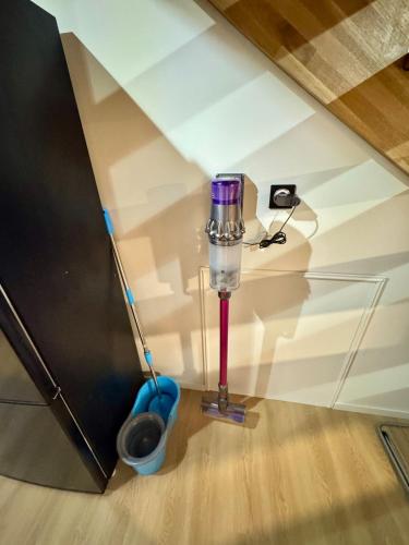 a room with a vacuum cleaner and a cup on the floor at L'Echappée Belle in Laguiole