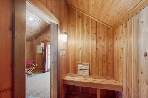 a wood paneled hallway with a sign in a room at Owls' Hollow in West Dover