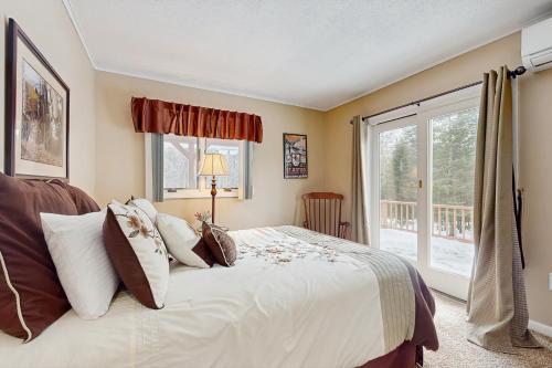 a bedroom with a large bed and a window at Owls' Hollow in West Dover