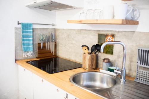a kitchen with a sink and a counter top at Mar - Boutique Garden Ocean View Suite in the Countryside - Vila Pilar in Ponta Delgada