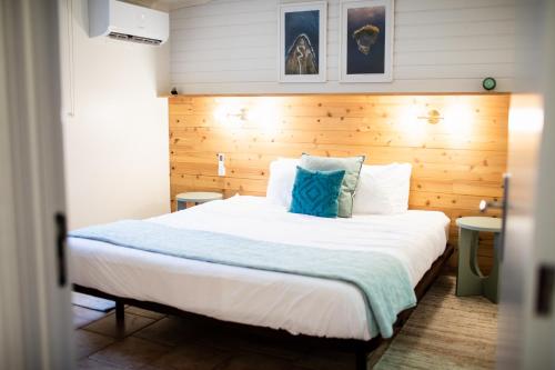 a bedroom with a large bed with a wooden headboard at Mar - Boutique Garden Ocean View Suite in the Countryside - Vila Pilar in Ponta Delgada