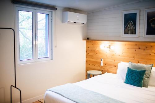 a bedroom with a white bed and a window at Mar - Boutique Garden Ocean View Suite in the Countryside - Vila Pilar in Ponta Delgada