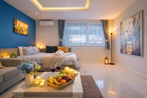 a living room with a couch and a table with a bowl of fruit at N9 Studentski Loft - Cozy Apt with Private Parking in Sofia