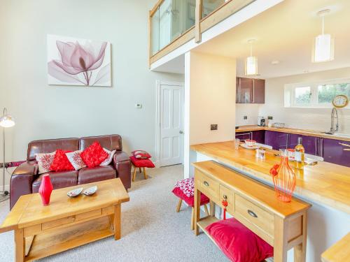 a living room with a couch and a table at Hallmark Lodge in Tenterden