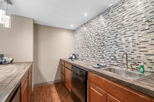 a kitchen with a sink and a brick wall at Best Western Courtview Hotel in Springfield
