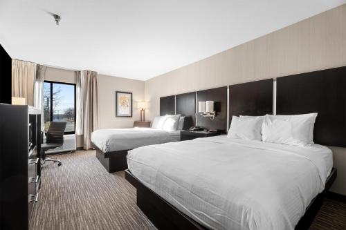 a hotel room with two beds and a television at Best Western Courtview Hotel in Springfield