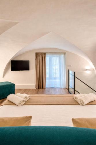 a room with two beds and a large window at Dimore Sangiuliano in Catania