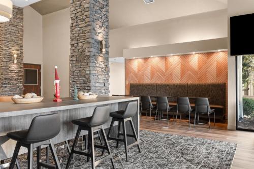 a bar in a lobby with black stools at Best Western Courtview Hotel in Springfield