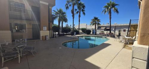 a swimming pool in the middle of a building with palm trees at SureStay by Best Western Mesa Downtown Area in Mesa