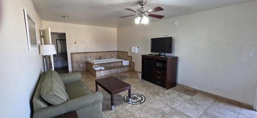 a living room with a couch and a flat screen tv at SureStay by Best Western Mesa Downtown Area in Mesa