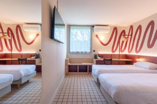 a room with three beds with red decorations on the walls at Best Western Hôtel du Phare in Mérignac