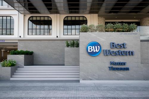 a building with a sign for the best western water fluorinator at Best Western Matter Tiwanon Hotel in Bangkok