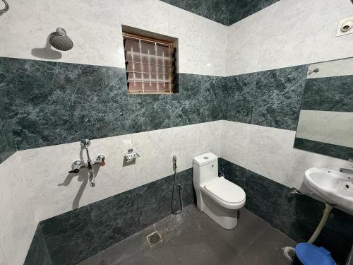 a bathroom with a toilet and a sink at Lila Niwas in Udaipur