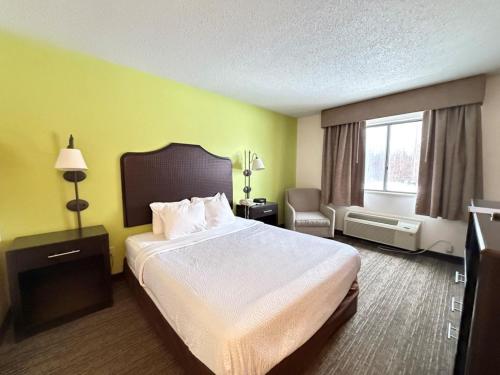 a hotel room with a large bed and a window at SureStay by Best Western Grove City in Grove City