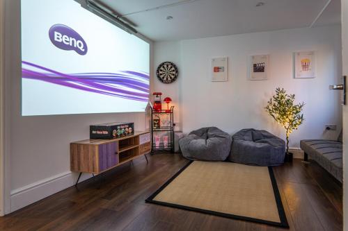 a living room with a large screen in the wall at Cranberry House Stylish 3BR, 7 Guests Contractor with Cinema Room Near JLR NEC and Airport in Sheldon