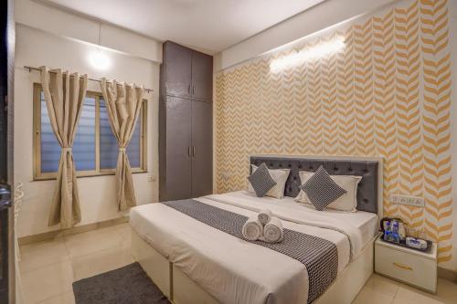 a bedroom with a bed with shoes on it at Urban Villa ,Baner in Pune