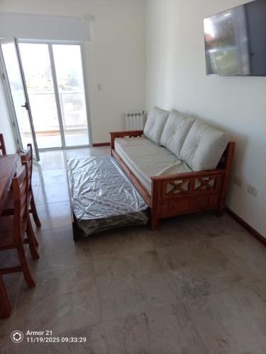 a living room with a couch and a table and a table at Los corales torre norte in Santa Teresita