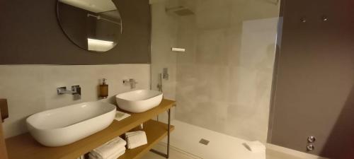 a bathroom with a white sink and a mirror at Fruit Village Torre dell'Orso La Brunese 4stelle in Torre dell'Orso