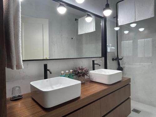 a bathroom with two white sinks and a mirror at Mouzinho50 - Elegant Apartment in Póvoa de Varzim