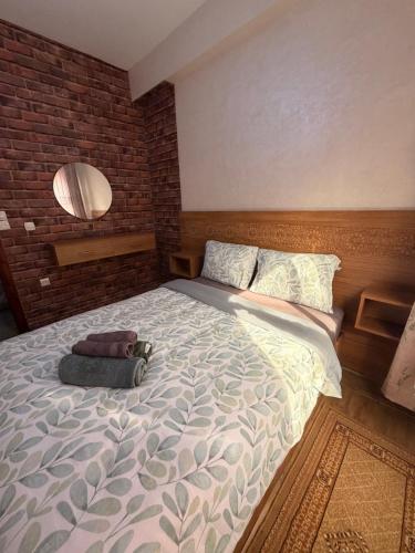 a bedroom with a large bed with a bag on it at Julie Airport Boarding Apartment in Marrakesh
