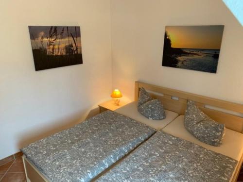 a bedroom with a bed and a lamp on a table at Küstenliebe in Kirchdorf