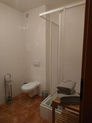 a bathroom with a toilet and a bath tub at Küstenliebe in Kirchdorf