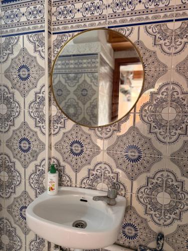 a bathroom with a sink and a mirror at Julie Airport Boarding Apartment in Marrakesh