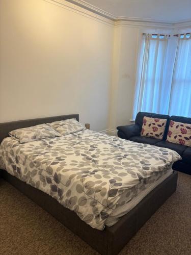 a bedroom with a bed and a couch at Palace in Crystal Palace
