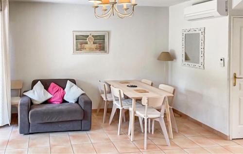 a living room with a table and a chair at Maison 1 in Montauroux